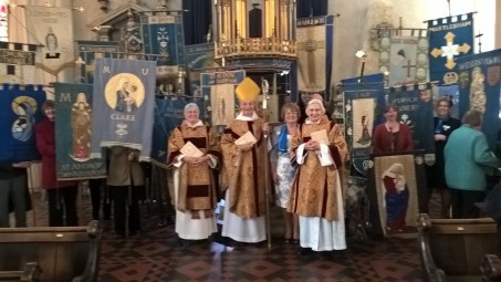 Photo of Bishop Mike with the MU banners at the Lady Day service